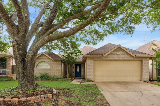 single story home featuring roof with shingles, a front lawn, driveway, a garage, and brick siding