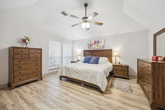 bedroom with vaulted ceiling, visible vents, light wood-style floors, and ceiling fan