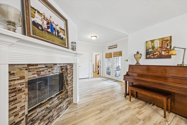 1807 Emerald Green Dr, Houston, TX 77094 - living area featuring french doors, a glass covered fireplace, wood finished floors, and ornamental molding