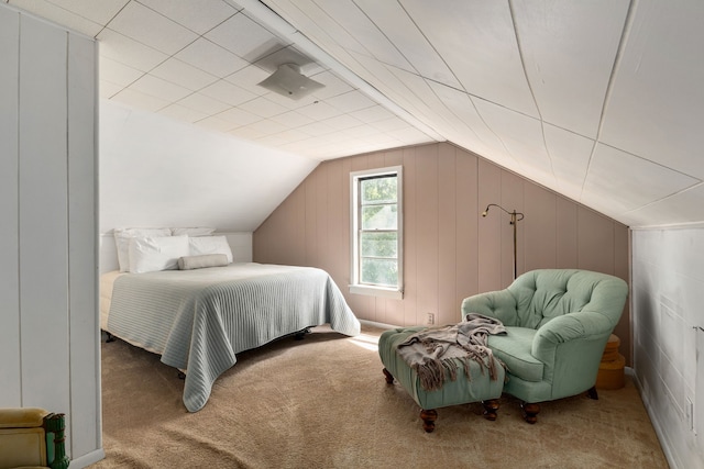 bedroom featuring lofted ceiling and carpet
