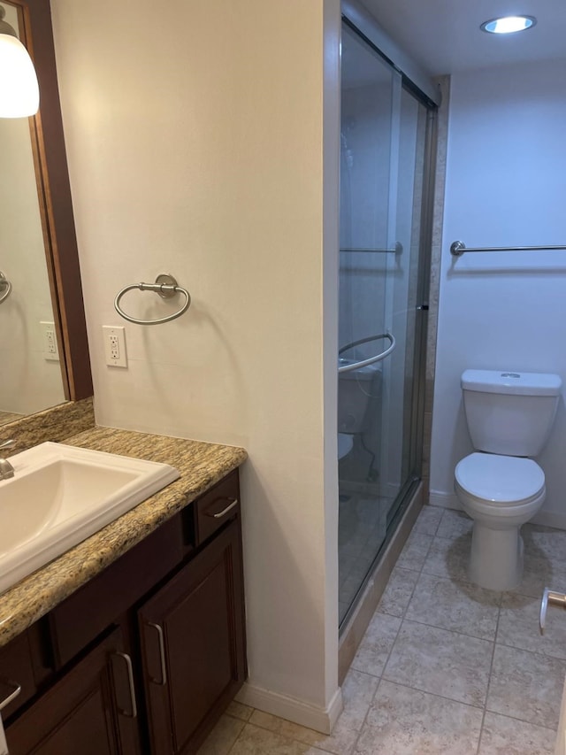 3525 Sage Rd Unit 1204, Houston, TX 77056 - bathroom featuring toilet, tile patterned floors, a stall shower, vanity, and baseboards