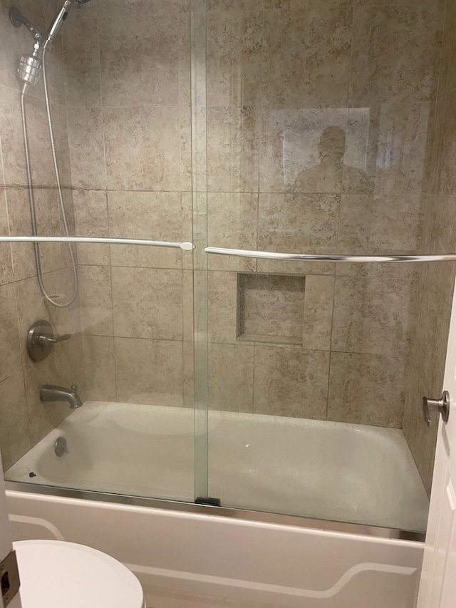 3525 Sage Rd Unit 1204, Houston, TX 77056 - bathroom featuring bath / shower combo with glass door and toilet