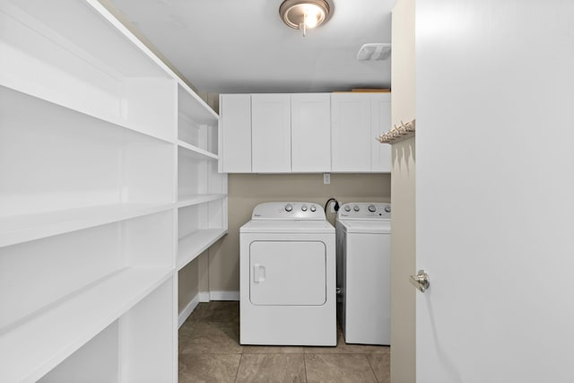 laundry room featuring visible vents, light tile patterned floors, independent washer and dryer, baseboards, and cabinet space
