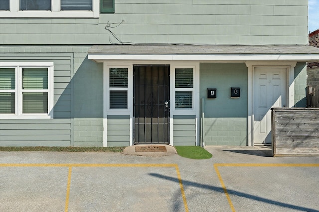 property entrance with uncovered parking