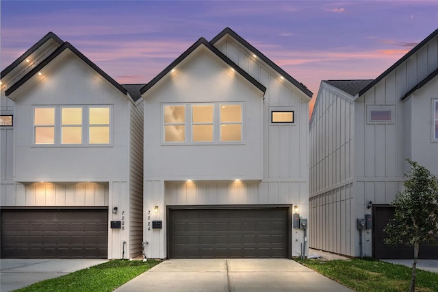 7228 Ave B, Houston, TX 77011 - modern farmhouse style home with board and batten siding, an attached garage, and concrete driveway
