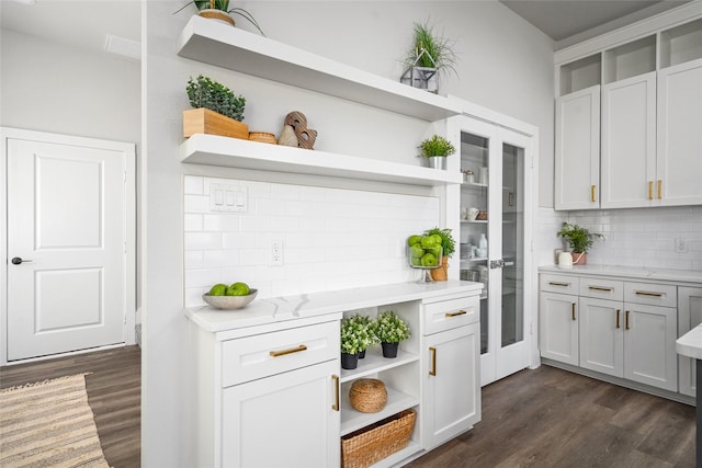 7228 Ave B, Houston, TX 77011 - kitchen with open shelves, backsplash, dark wood-style floors, and light stone countertops