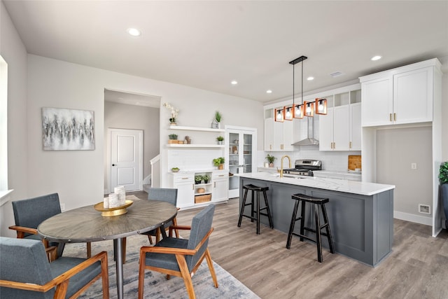 dining area featuring light wood-style flooring and recessed lighting