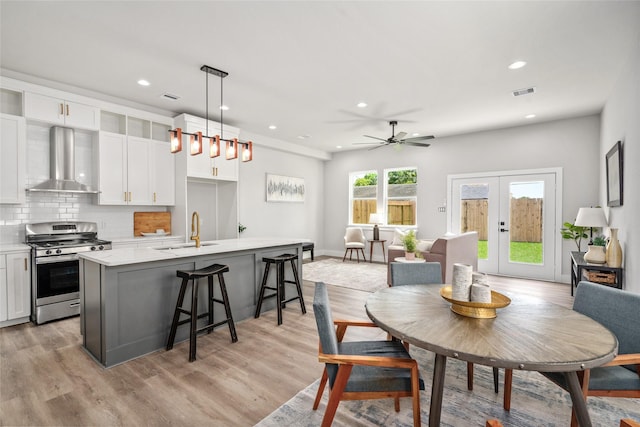 dining room with french doors, recessed lighting, light wood finished floors, a ceiling fan, and baseboards