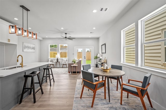 dining room featuring french doors, recessed lighting, light wood-style flooring, and ceiling fan
