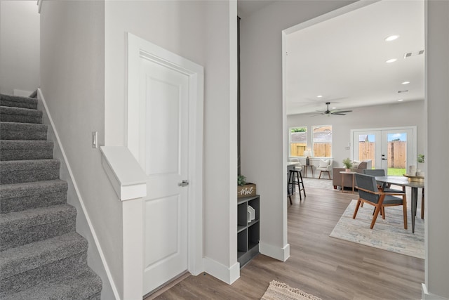 7228 Ave B, Houston, TX 77011 - stairway featuring wood finished floors, ceiling fan, recessed lighting, and french doors