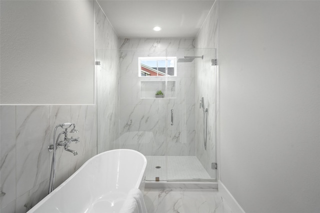 7228 Ave B, Houston, TX 77011 - bathroom with a soaking tub, a marble finish shower, and marble finish flooring
