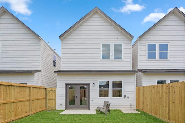 7228 Ave B, Houston, TX 77011 - back of property with french doors, a fenced backyard, and a patio
