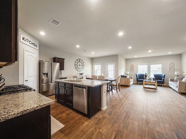 2423 Staverton Cir, Spring, TX 77373 - kitchen featuring dark wood finished floors, light stone counters, stainless steel appliances, and recessed lighting