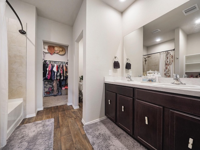 2423 Staverton Cir, Spring, TX 77373 - bathroom with double vanity, wood finished floors, visible vents, a sink, and a shower with shower curtain