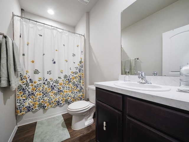 2423 Staverton Cir, Spring, TX 77373 - bathroom with wood finished floors, toilet, vanity, shower / tub combo with curtain, and baseboards