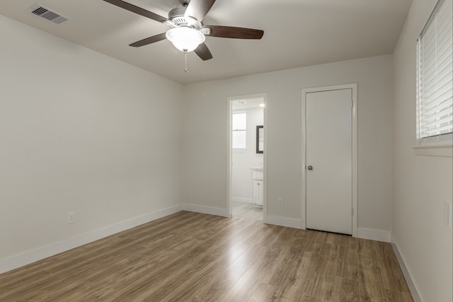 4206 Oak Shadows Dr, Houston, TX 77091 - empty room with light wood-style flooring, visible vents, a ceiling fan, and a wealth of natural light