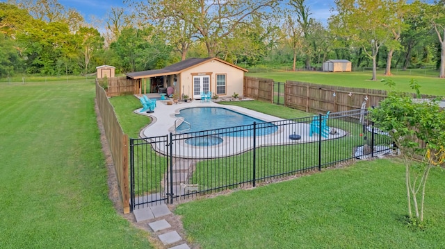 view of swimming pool with a fenced backyard, an outdoor structure, a storage shed, and a yard