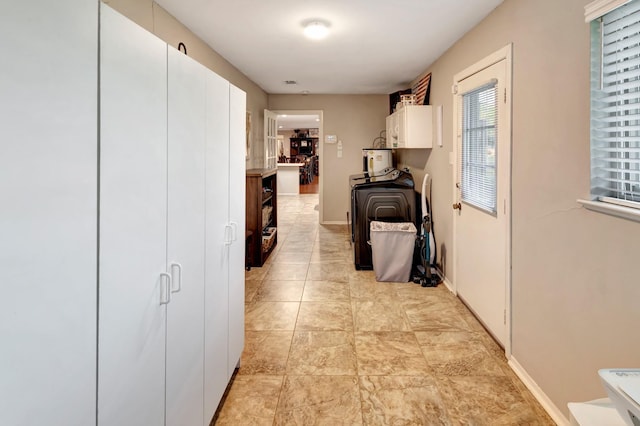hall featuring baseboards