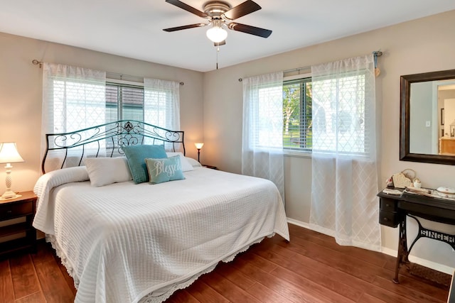bedroom with hardwood / wood-style flooring, baseboards, and a ceiling fan