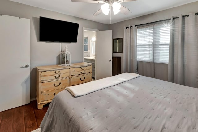 bedroom with baseboards, dark wood-style floors, ceiling fan, and connected bathroom