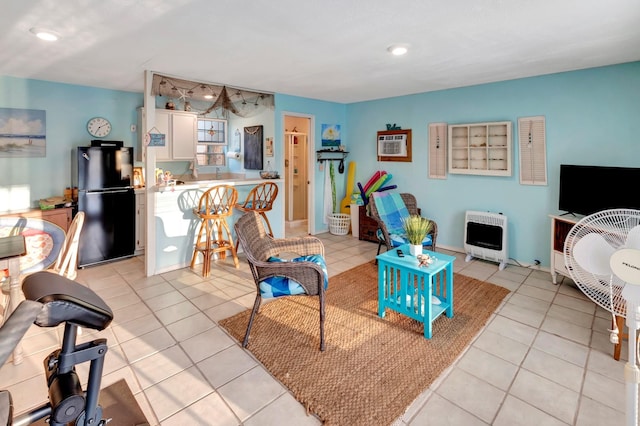living room with heating unit, recessed lighting, and light tile patterned flooring