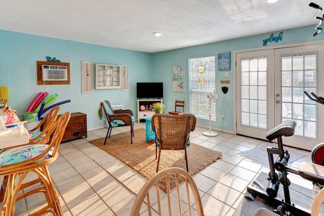 living room featuring french doors, a wall mounted AC, light tile patterned floors, and a healthy amount of sunlight