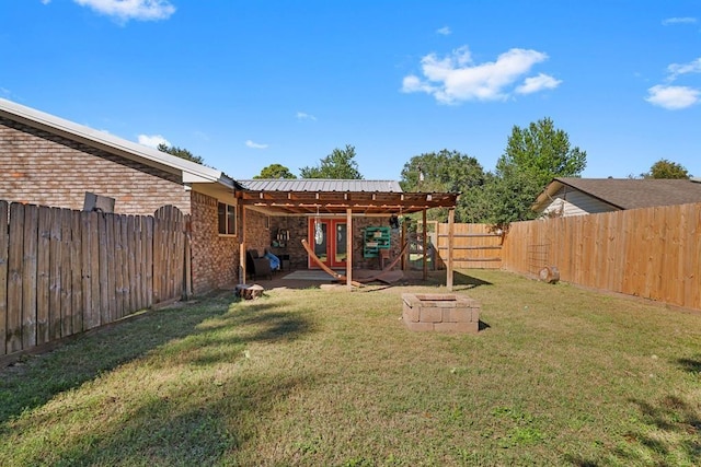 view of yard with a patio area, a fenced backyard, and an outdoor fire pit