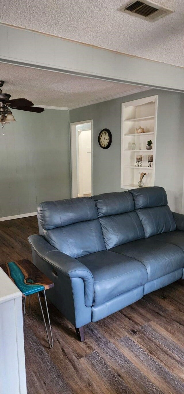 living area with wood finished floors, a textured ceiling, and ceiling fan