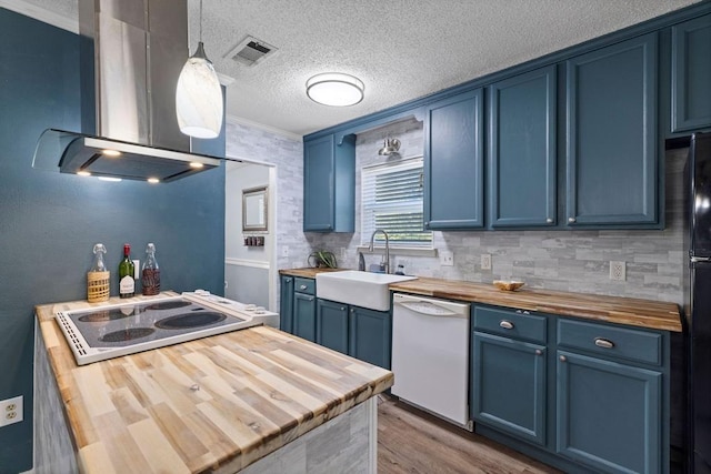 kitchen featuring wood counters, island exhaust hood, dishwasher, and blue cabinetry