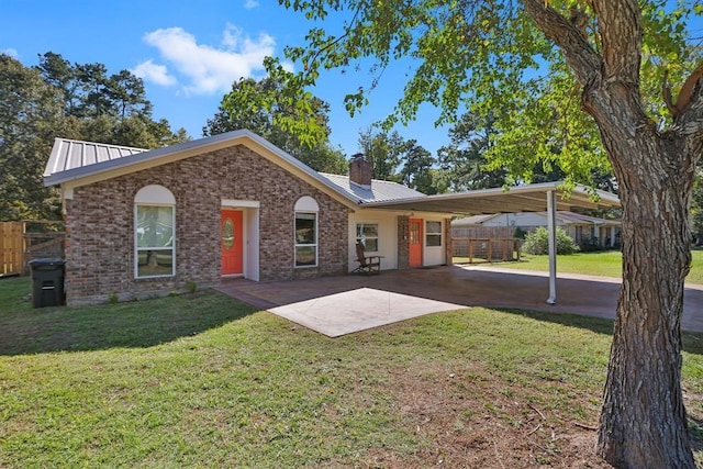 ranch-style house featuring brick siding, fence, a front yard, and metal roof