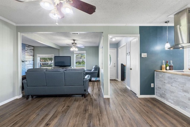 living room with ceiling fan and a textured ceiling