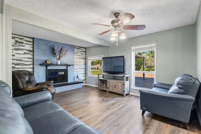 living room featuring plenty of natural light, wood finished floors, and a textured ceiling