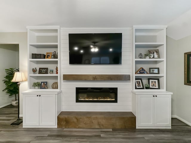 2222 E Winding Pines Dr, Tomball, TX 77375 - living room with dark wood finished floors, baseboards, built in features, and a fireplace