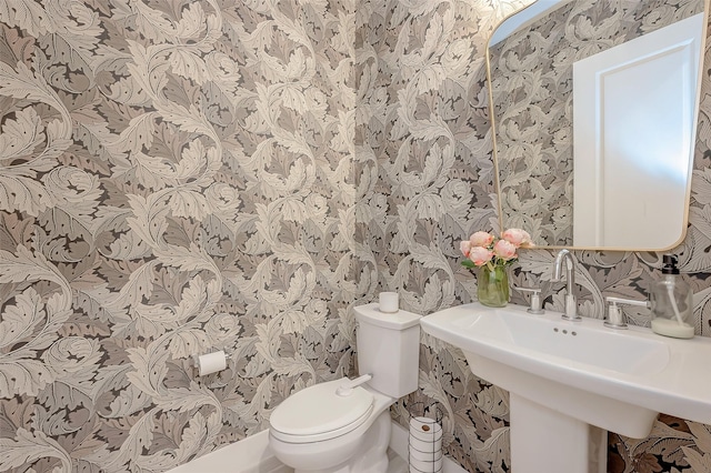 2418 Huldy St Unit B, Houston, TX 77019 - half bathroom featuring wallpapered walls, toilet, and a sink