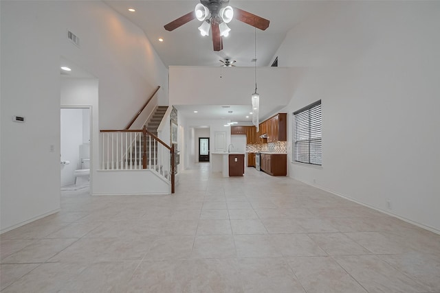 24543 Carlton Springs Ln, Katy, TX 77494 - unfurnished living room featuring stairs, ceiling fan, high vaulted ceiling, recessed lighting, and light tile patterned floors