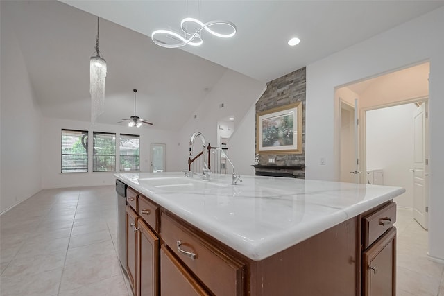 24543 Carlton Springs Ln, Katy, TX 77494 - kitchen with a sink, light tile patterned floors, hanging light fixtures, ceiling fan, and open floor plan