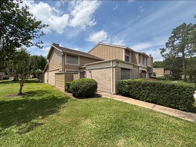 2332 Woodland Park Dr Unit 11, Houston, TX 77077 - view of side of property featuring brick siding and a yard