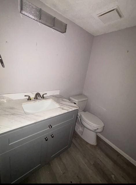 2332 Woodland Park Dr Unit 11, Houston, TX 77077 - half bath featuring wood finished floors, toilet, vanity, and baseboards
