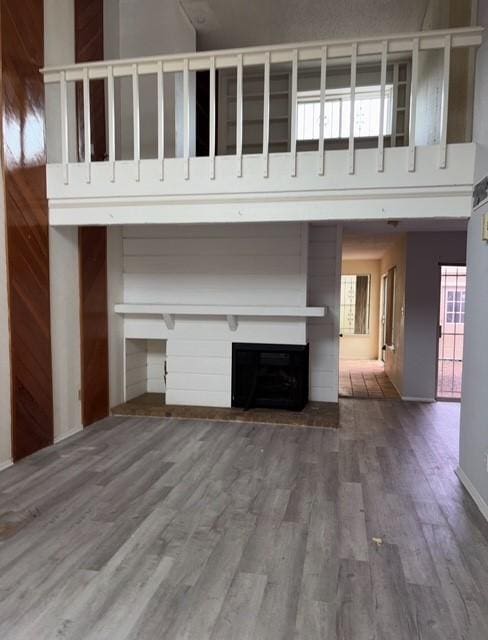 2332 Woodland Park Dr Unit 11, Houston, TX 77077 - unfurnished living room featuring wood finished floors, a fireplace, and healthy amount of natural light