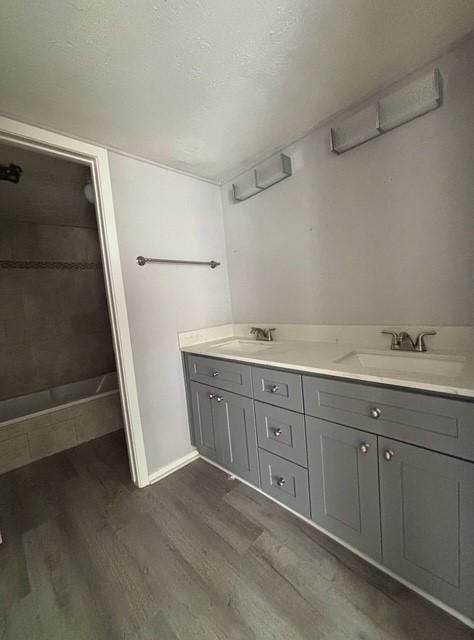 2332 Woodland Park Dr Unit 11, Houston, TX 77077 - bathroom with wood finished floors, baseboards, and double vanity
