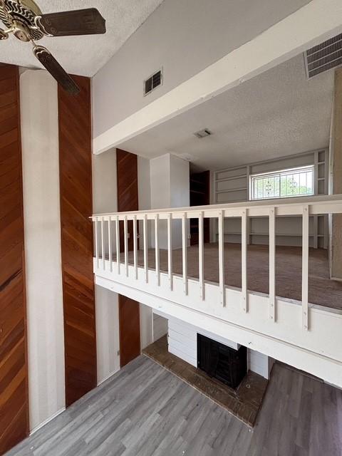 2332 Woodland Park Dr Unit 11, Houston, TX 77077 - stairs featuring a textured ceiling, wood finished floors, and a ceiling fan