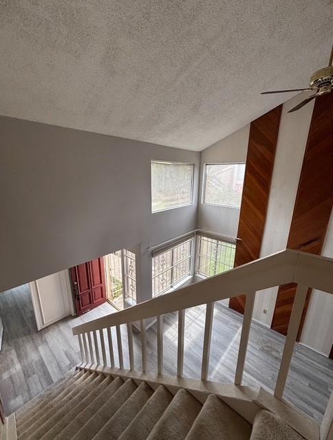 2332 Woodland Park Dr Unit 11, Houston, TX 77077 - stairs featuring a textured ceiling, vaulted ceiling, ceiling fan, and wood finished floors