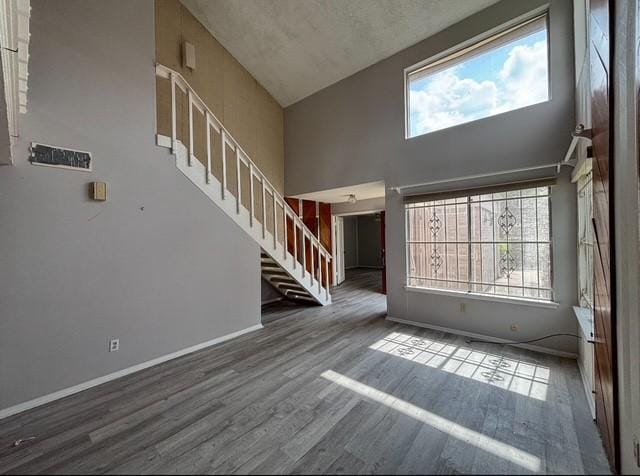 2332 Woodland Park Dr Unit 11, Houston, TX 77077 - foyer entrance featuring stairs, wood finished floors, a high ceiling, and baseboards