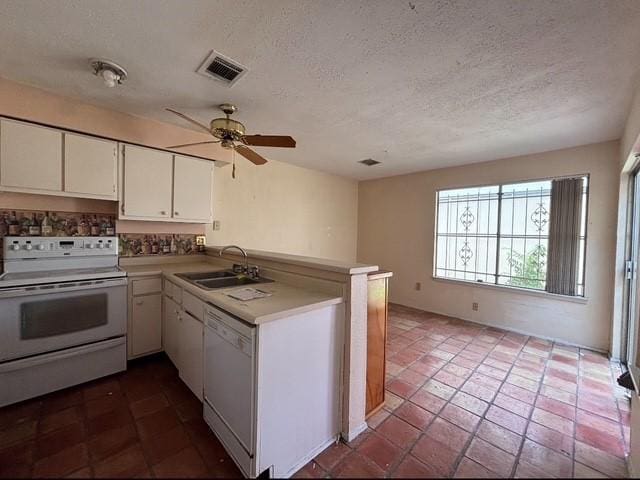 2332 Woodland Park Dr Unit 11, Houston, TX 77077 - kitchen with white appliances, a sink, a peninsula, white cabinetry, and a textured ceiling