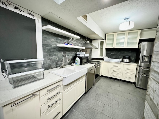 kitchen with open shelves, stainless steel appliances, a sink, and decorative backsplash