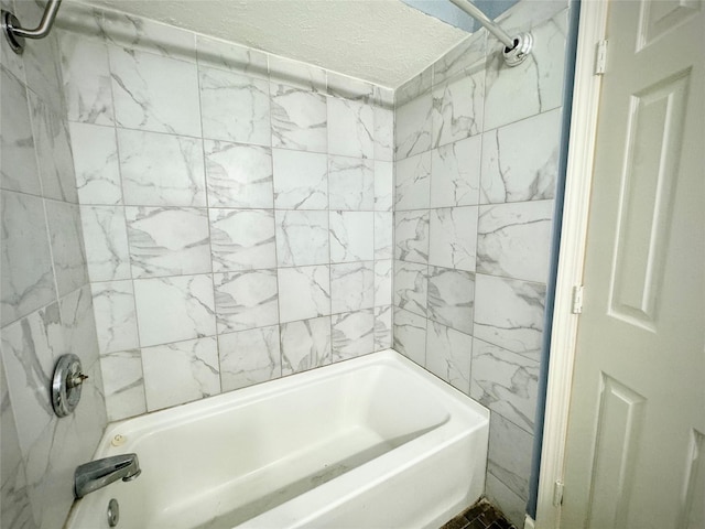 full bath featuring a textured ceiling and shower / washtub combination