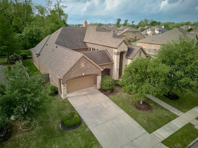 21315 Whistle Wood Dr, Richmond, TX 77406 - view of front of home with roof with shingles, driveway, a chimney, brick siding, and an attached garage