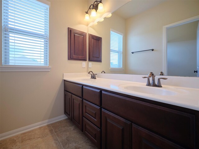21315 Whistle Wood Dr, Richmond, TX 77406 - full bathroom with double vanity, tile patterned floors, baseboards, and a sink