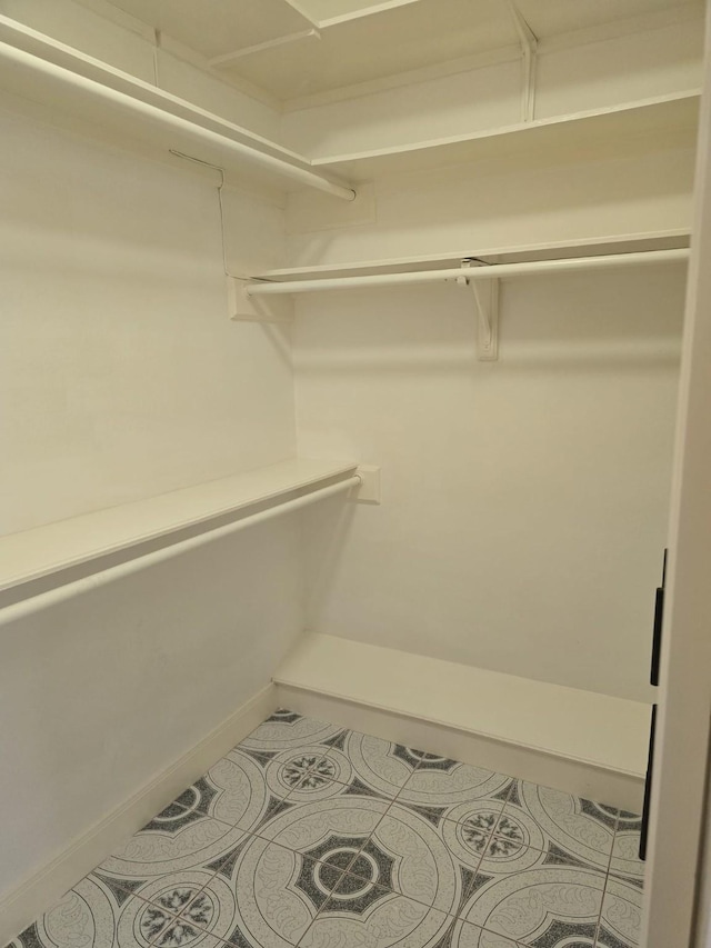 12203 Ashley Circle Dr E, Houston, TX 77071 - spacious closet featuring tile patterned floors