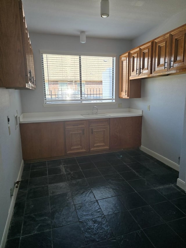 12203 Ashley Circle Dr E, Houston, TX 77071 - clothes washing area with baseboards, cabinet space, a sink, and washer hookup